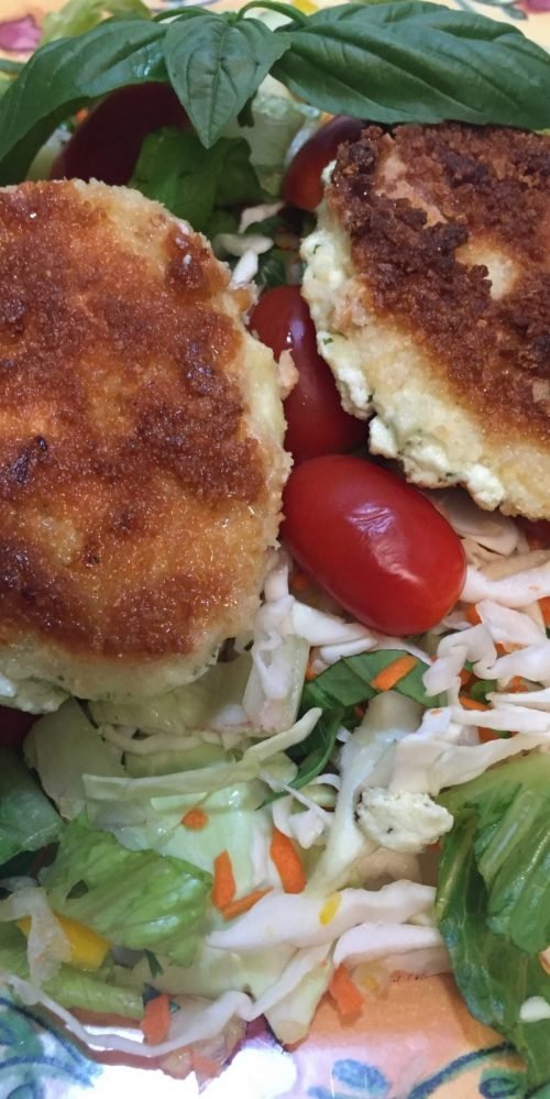 Baked goat cheese medallions on a crisp salad
